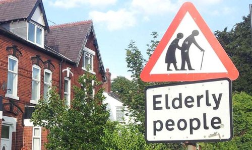 A triangle road sign reading 'elderly people'.