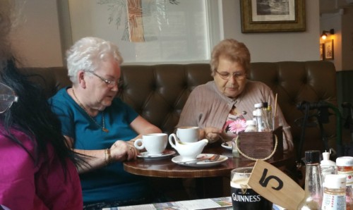 Two older ladies having tea.