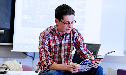 lecturer reading a magazine