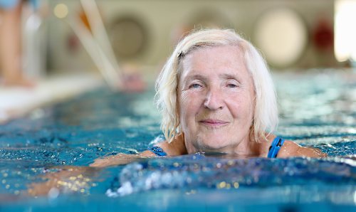 On older woman swimming in a pool.